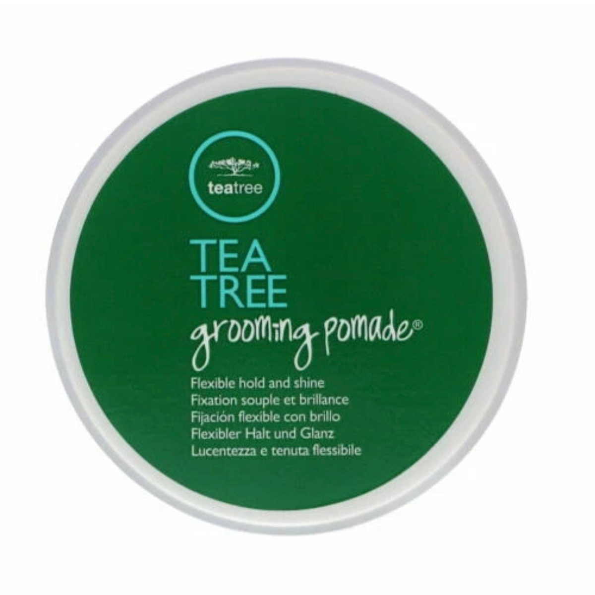 A round green container of Tea Tree Grooming Pomade by Tea Tree, featuring a white lid and white text on the front.