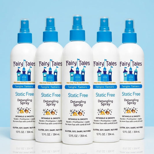 Five white spray bottles of Fairy Tales Static Free Detangling Spray lined up on a light blue background.