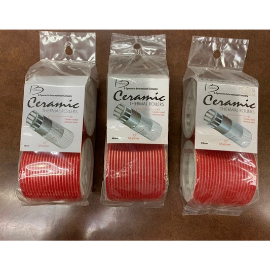 Three packaged rolls of ceramic thermal cooling pastes shown side-by-side on a brown surface. 